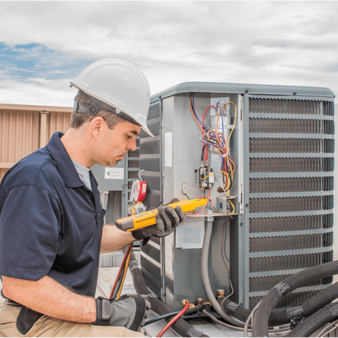 Chatham Heating and Cooling HVAC technician servicing a system